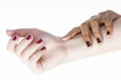 two different nathion manicured hands on white isolated, african with caucasian close up
