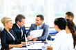 © ASDF - Image of business partners discussing documents and ideas at meeting