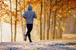 © baranq - Young man running in the park during autumn morning