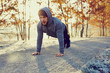 © baranq - Young runner doing push ups exercise during cold autumn morning