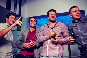 Wall Mural - group of male friends with beer in nightclub