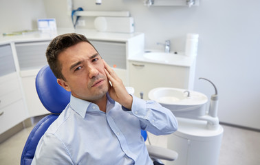 Sticker - man having toothache and sitting on dental chair