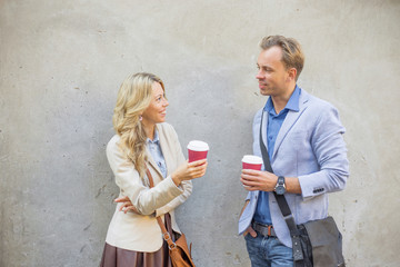 Man and woman standing by the wall and talking