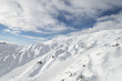 Sunny day winter alpine landscape of ski resort woth ski snowboard trails