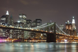 Fototapeta  - The Brooklyn Bridge and Manhattan skyline as seen from across the East River at dusk.
