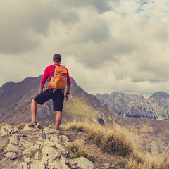 Hiking man or trail runner in mountains