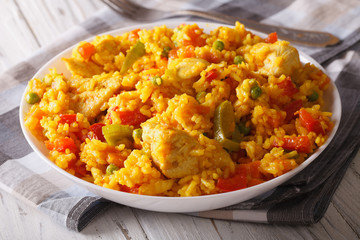 Hispanic cuisine: Arroz con pollo close up in a bowl. Horizontal
