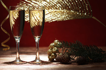 Two champagne glasses on wooden table