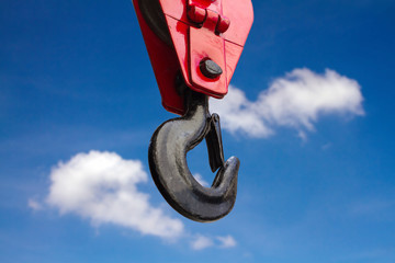 Close up of heavy-duty steel hook on blue sky background