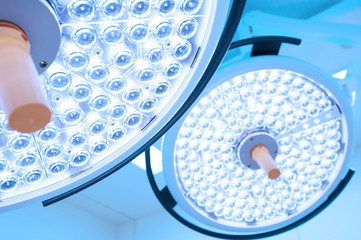 Wall Mural - Two surgical lamps in operation room take with art lighting and blue filter