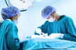 © nimon_t - two veterinarian surgeons in operating room take with art lighting and blue filter