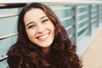 cute brunette woman laughing in the street
