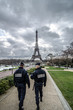 Paris , Paris Security agents guard the Eiffel Tower / Paris, France - March 18, 2012: Patrols of two police officers in the Trocadero gardens and Eiffel Tower.