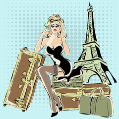 Wall Mural - Beautiful pin-up woman sitting on suitcases near Eiffel Tower Paris