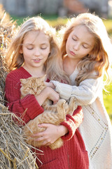 Wall Mural - portrait of two sisters during the autumn harvest