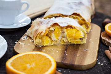 Strudel with custard and orange. Christmas Stollen. Christmas table decoration.