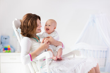 mother and baby in white bedroom