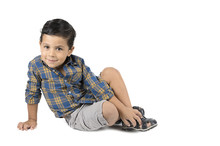 Cute Little Boy Sitting Isolated On White Background.