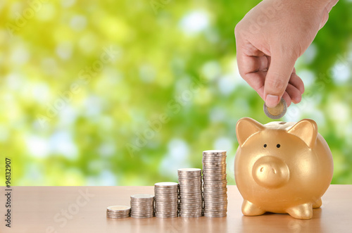 Fotografía man hand with coins plan to saving money with gold piggy bank