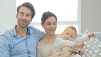 Wall Mural - Portrait of happy young family of three