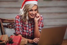 Blonde Woman Wearing Santa Hat, Working With Laptop
