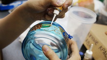 Painting With  Stained Glass Paints And Line Paints On Transparent Blue Glass Jar