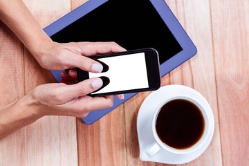 Poster - Businesswoman using her smartphone on desk
