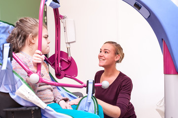 Disabled girl being lifted into wheelchair / Disabled girl being lifted into wheelchair with help from a lift and care assistant