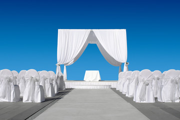 Wedding canopy with chairs, all in white on blue sky