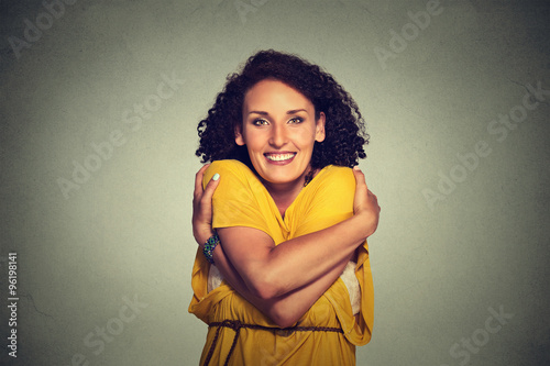 Fotomural happy smiling woman holding hugging herself