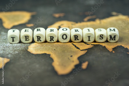 Fotomural Wooden blocks with the text, TERRORISM, on the background of world map