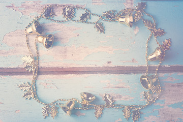 Christmas gold bell chain decorative on grunge blue wooden backg