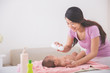 © Odua Images - mother applying powder to her baby after bath