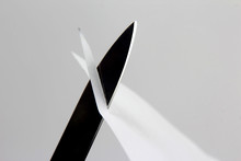  Blade Of A Sharp Knife Cut Across The White Paper