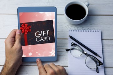 Composite image of gift card with festive bow