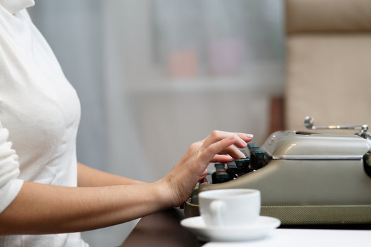 Hands writing on typewriter
