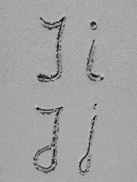 Sand font or letter set or collection on an exotic beach near the sea in summer