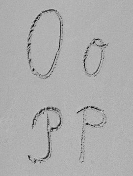 Sand font or letter set or collection on an exotic beach near the sea in summer