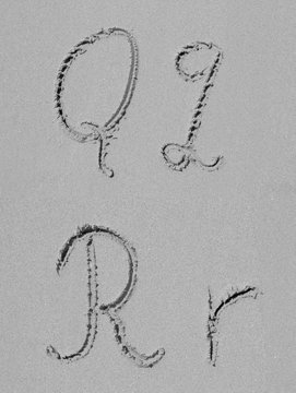 Sand font or letter set or collection on an exotic beach near the sea in summer