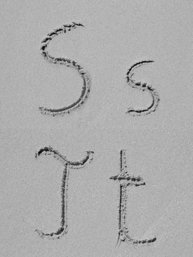 Sand font or letter set or collection on an exotic beach near the sea in summer