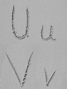 Sand font or letter set or collection on an exotic beach near the sea in summer