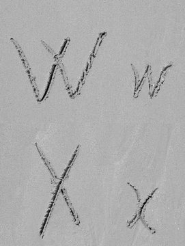 Sand font or letter set or collection on an exotic beach near the sea in summer