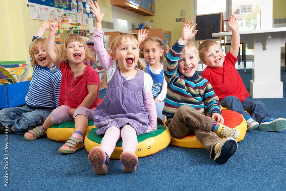 Group Of Pre School Children Answering Question In Classroom - obrazy, fototapety, plakaty 