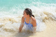 © yongkiet - Girl in a blue swimsuit playing splashing water at the sea near beach with happiness during summer at Koh Miang Island, Mu Ko Similan National Park, Phang Nga province, Thailand