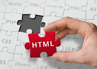 hand of programmer holds puzzle with html programming language