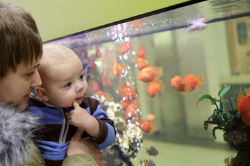 Mother with her baby at aquarium