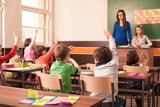 Fototapeta  - Children in elementary school are raised hand in clasroom