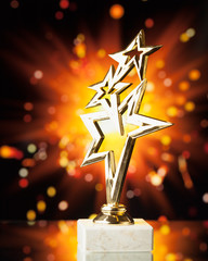 Wall Mural - gold stars trophy against shiny sparks background