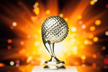 Wall Mural - golf ball trophy against shiny sparks background