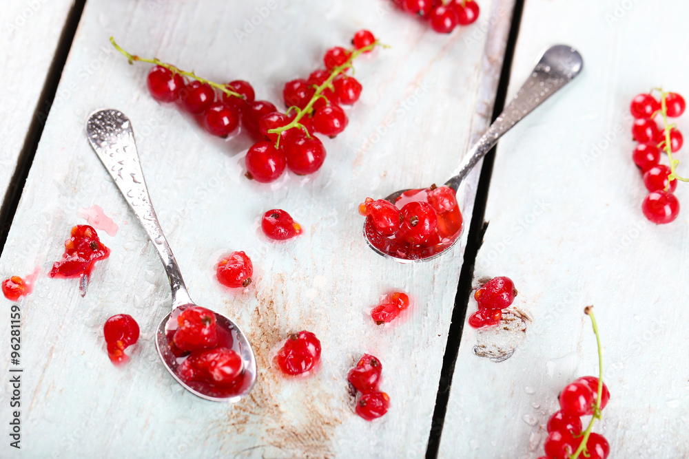 Fresh red currants on wooden table close up